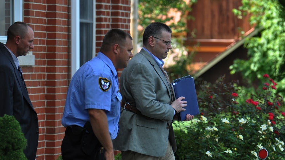 Daniel Messel is led out of the Brown County Courthouse and to a waiting car in Nashville, IN on Friday.