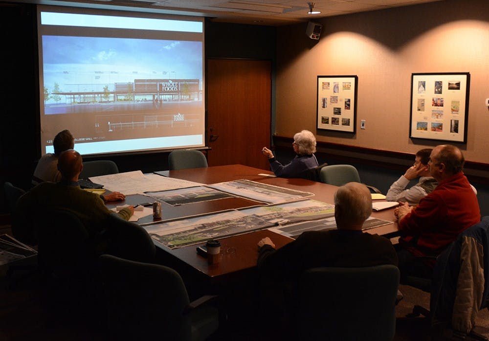 Members of the Planning and Transportation Department and the Plan Commission look at the construction site of College Mall and discuss the possibility of moving a Whole Food Market store into the area during a meeting held at City Hall on Monday. 