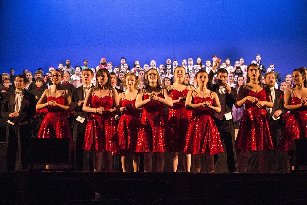 Members of the Singing Hoosiers rehearse for their Chimes of Christmas performance on Thursday evening at IU Auditorium.