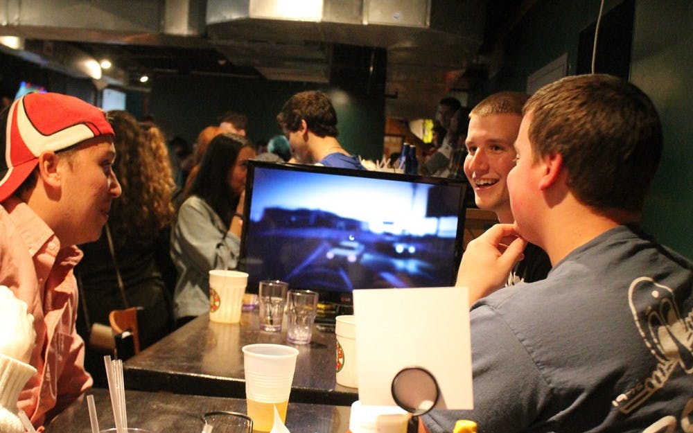 Skylar Booth,  Dylan Karnedy and Chris Neal, all members of Phi Kappa Tau, play video games that they brought to Kilroys on Kirkwood Monday afternoon. Many students bring games and other things to keep themselves entertained while participating in KOK's open to close. 