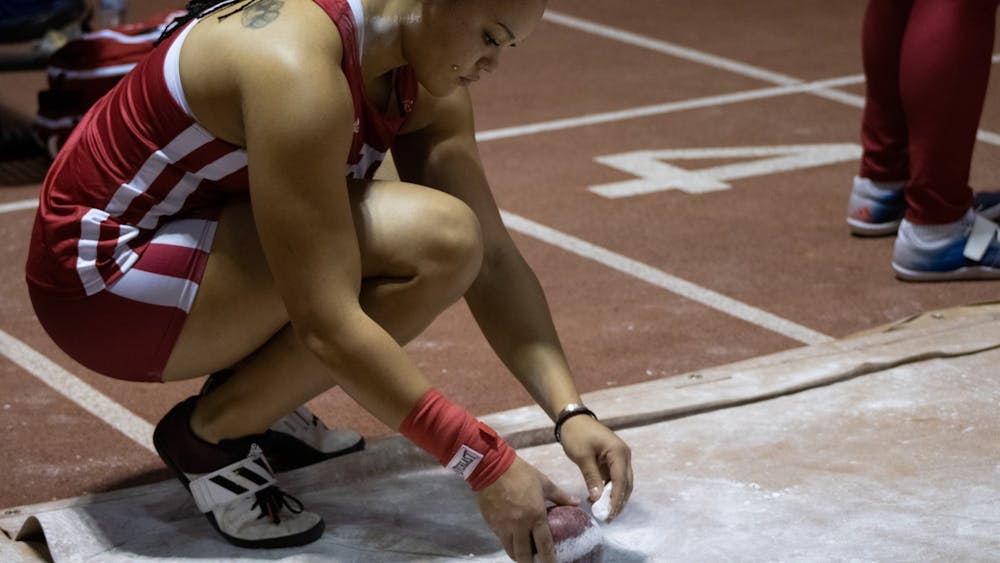 Freshman Jayden Ulrich puts chalk on her shot put ball at the Hoosier Hills meet Feb. 11, 2022, at Harry Gladstein Fieldhouse. 10 Indiana women’s track and field athletes qualified for the NCAA East Preliminary Round competition May 25-28.