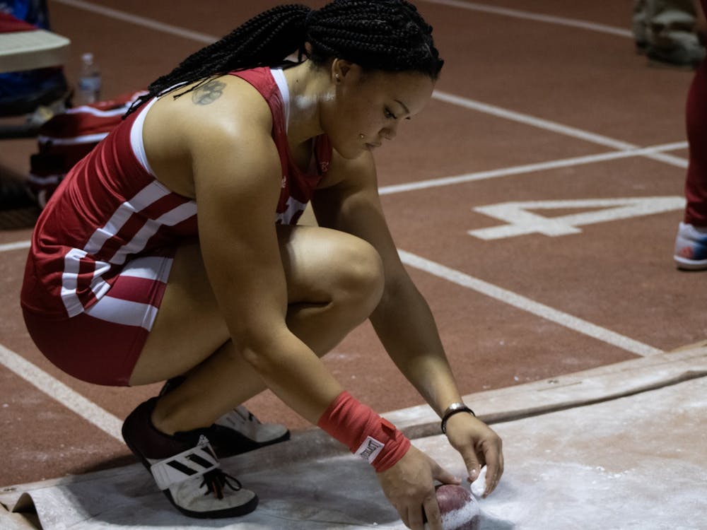 Freshman Jayden Ulrich puts chalk on her shot put ball at the Hoosier Hills meet Feb. 11, 2022, at Harry Gladstein Fieldhouse. 10 Indiana women’s track and field athletes qualified for the NCAA East Preliminary Round competition May 25-28.