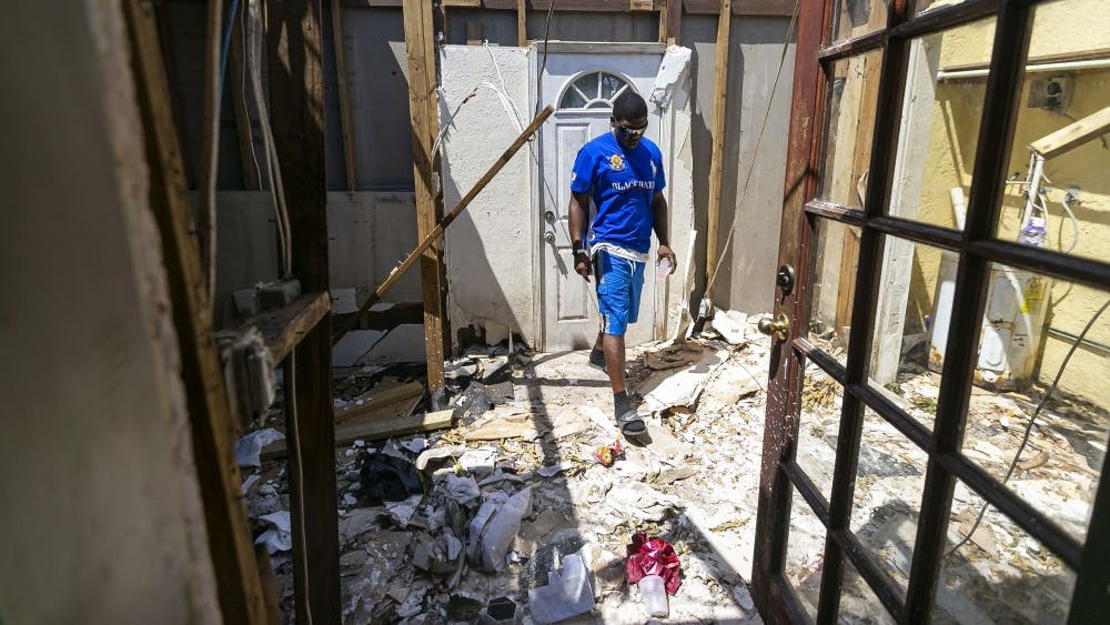 Ronnie Saunders, a machine operator at Freeport Harbor, surveys the wreckage done by Hurricane Dorian to his Royal Manners house Friday in Freeport, Bahamas. Saunders lives with his fiancée and 18-year-old daughter.