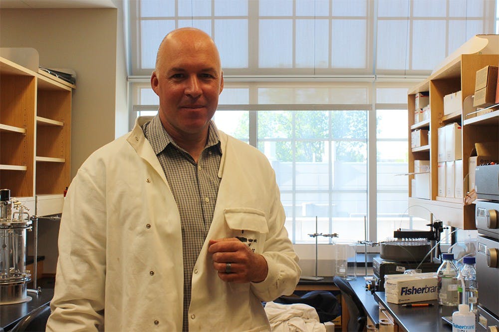 Stephen Bell, professor of biology, stands in his lab where he researches cell division in Simon Hall on Tuesday. Bell was recently named a fellow to the American Academy of Microbiology. 
