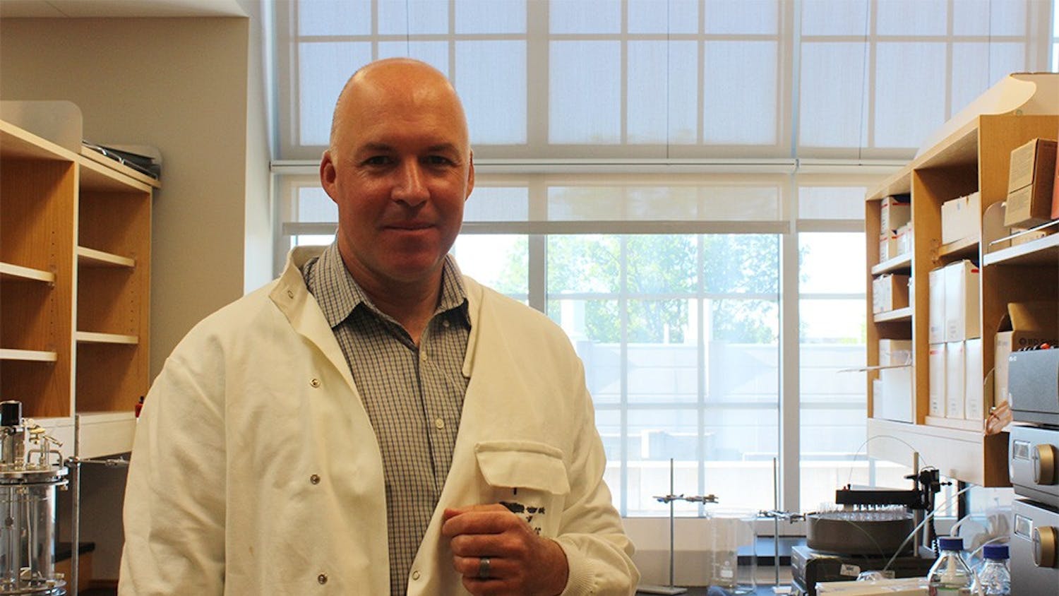 Stephen Bell, professor of biology, stands in his lab where he researches cell division in Simon Hall on Tuesday. Bell was recently named a fellow to the American Academy of Microbiology.