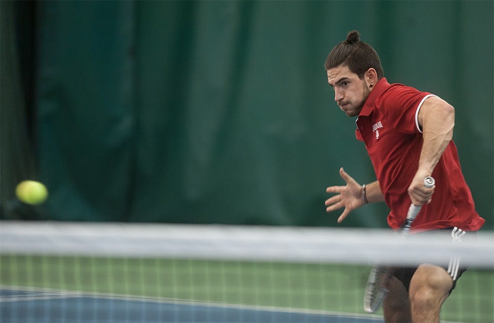 Sam Monette closing in to return with a volley against Sam Shropshire of Northwestern University on Friday at the IU Tennis Center. Monette lost the match 6-4, 7-5.