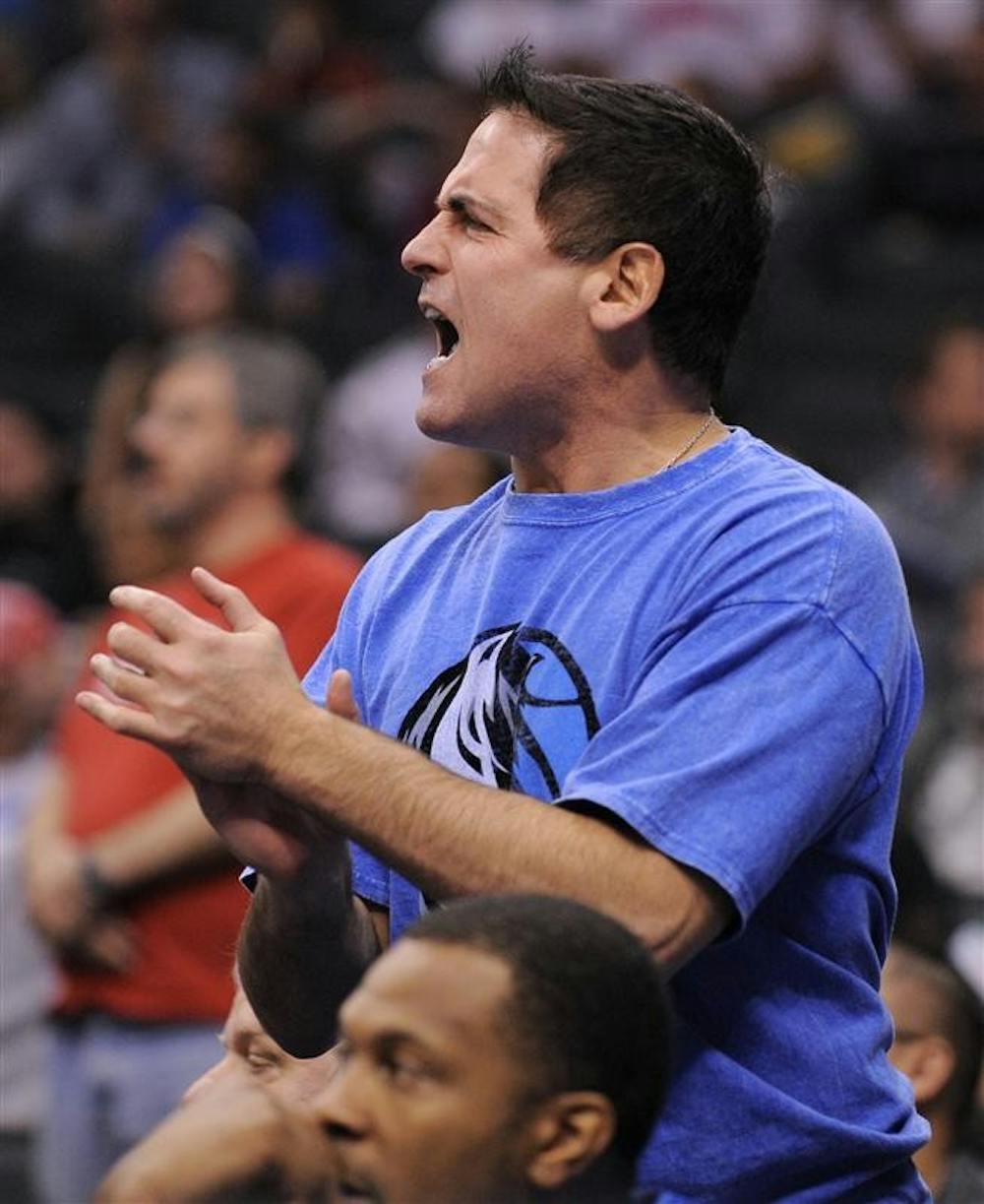 Dallas Mavericks owner Mark Cuban yells at referees during the second half of their NBA basketball game against the Los Angeles Clippers on Nov. 9 in Los Angeles. Cuban was charged with insider trading for allegedly using confidential information on a stock sale to avoid more than $750,000 in losses.
