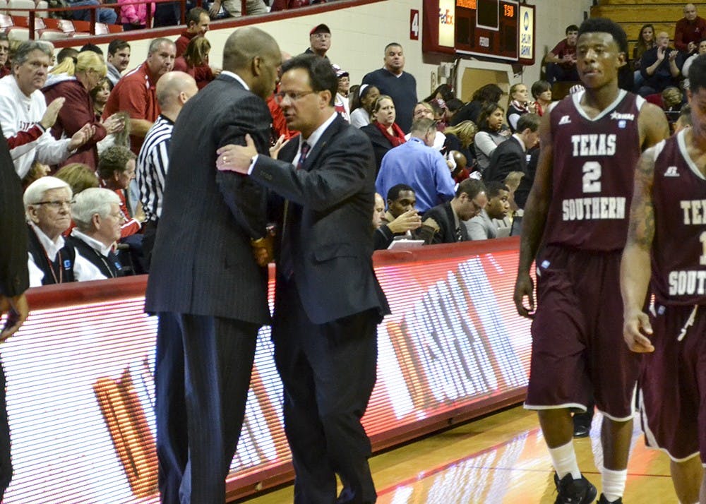 Head coach Tom Crean shakes hands with former IU coach Mike Davis after IU's game against Texas Southern on Monday at Assembly Hall. Monday's game was Davis's first game back at IU since 2006.