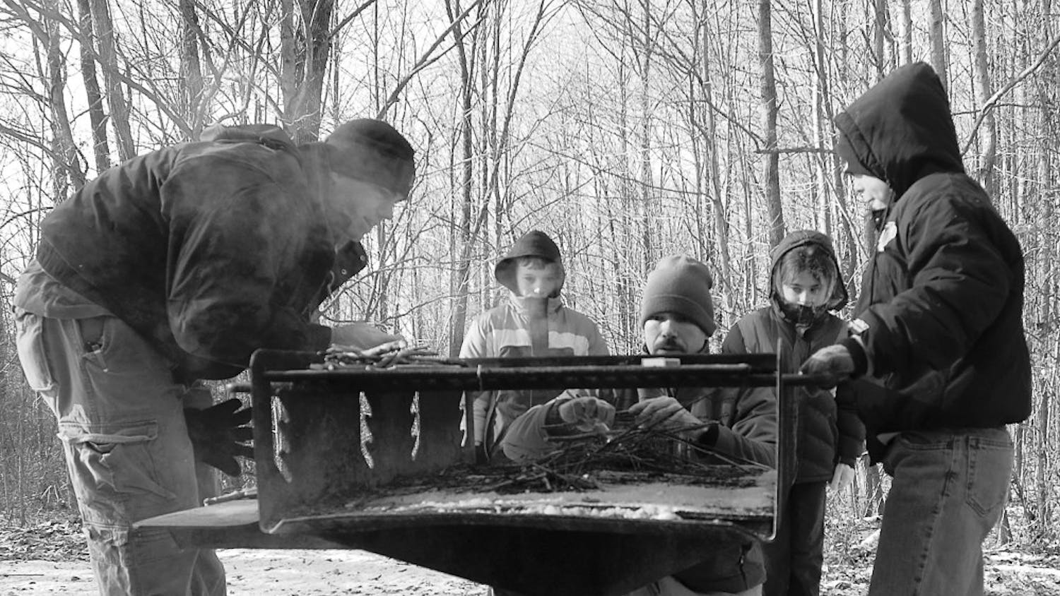 Participants attempt to build a fire during a class held by the Parks and Recreation Department.