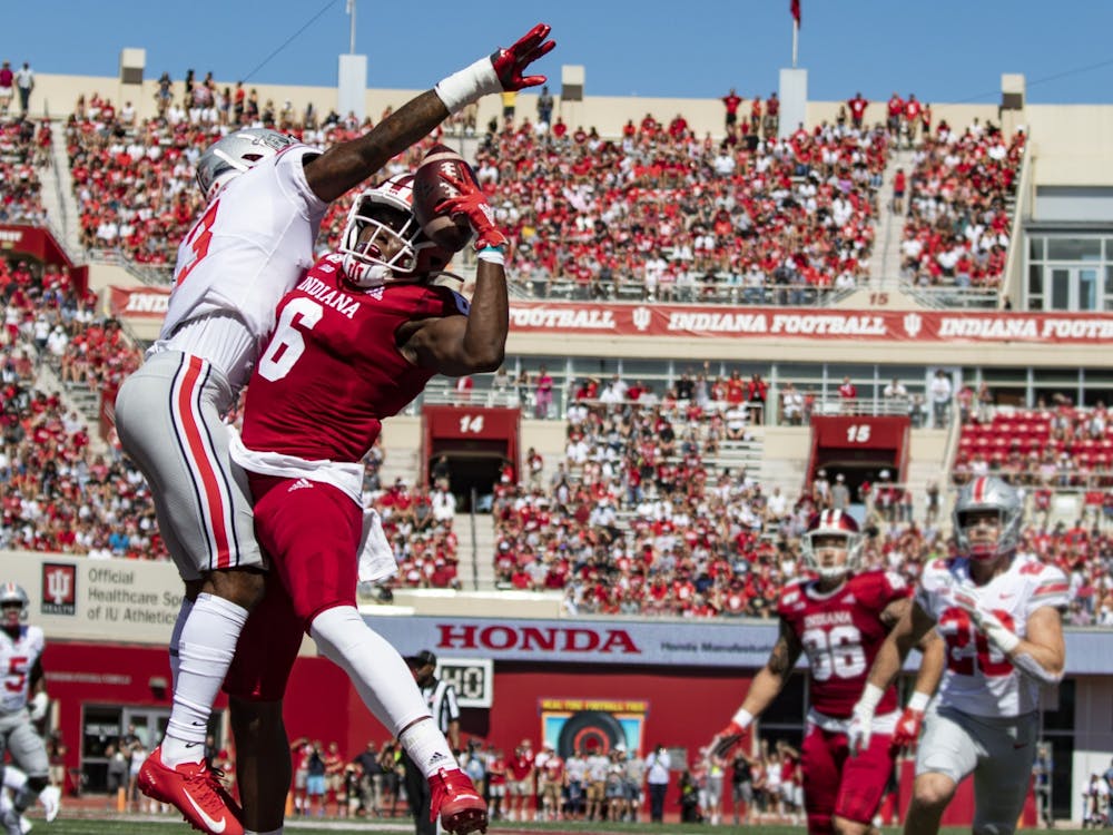 Fans fill the stadium behind fifth-year wide receiver Donavan Hale and an Ohio State defender Sept. 14 in Memorial Stadium. The stadium attendance was 91%, the highest attended home football game in 2019.