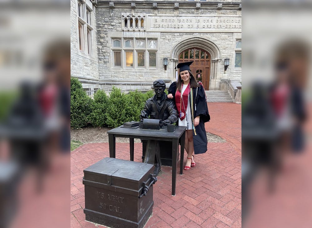 <p>Editor-in-chief Lydia Gerike poses for a photo May 7 next to the Ernie Pyle statue outside Franklin Hall.</p>