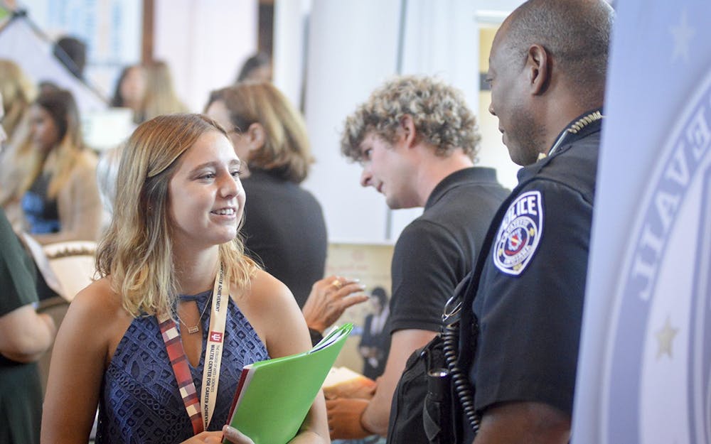 <p>Then-sophomore Elizabeth Nykaza speaks to the Lafayette County Police Department on Sept. 13, 2016, at the College of Arts and Sciences Career Fair in Alumni Hall. </p>