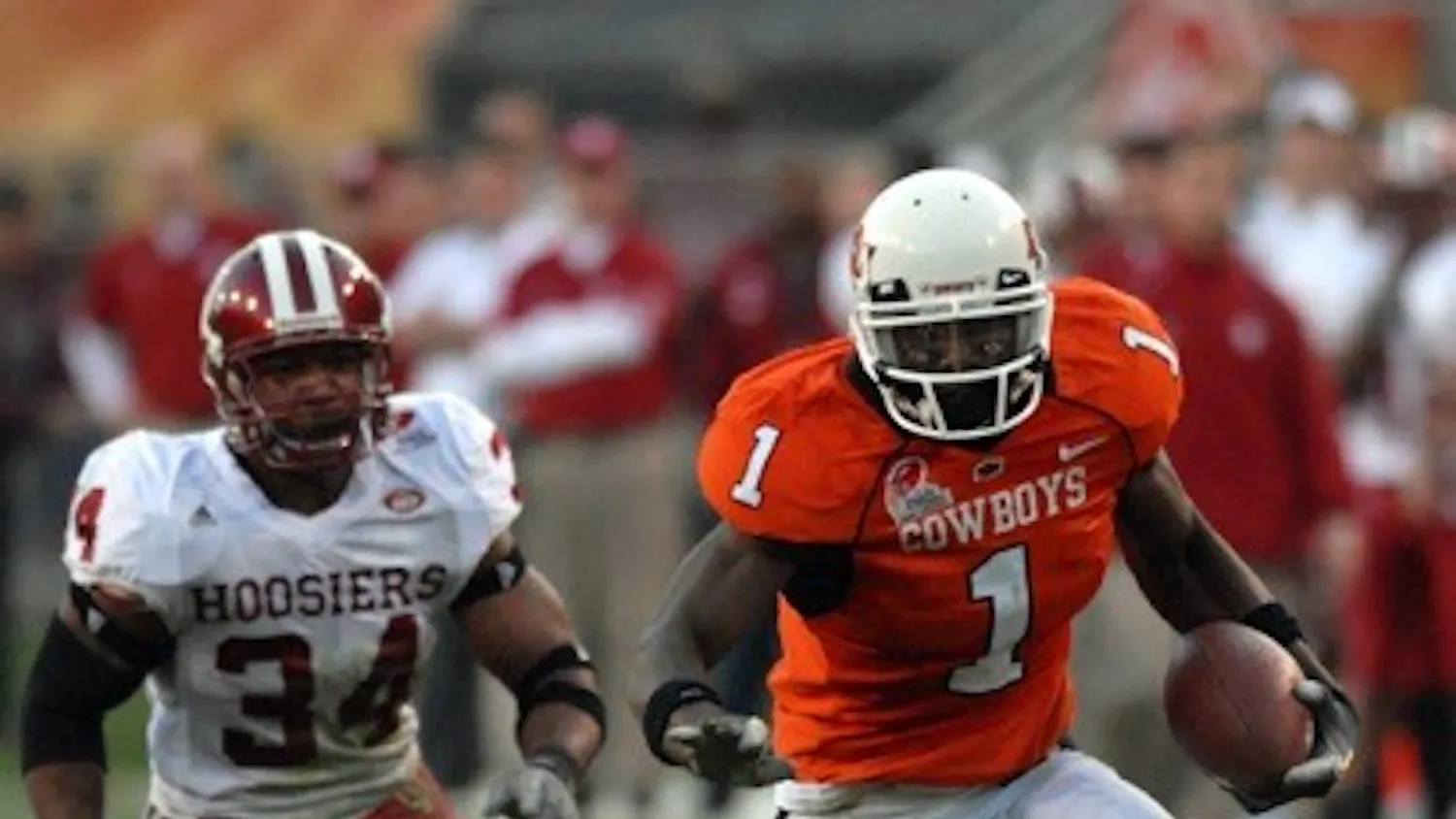 Jay Seawell • IDS
Oklahoma State freshman wide receiver Dez Bryant runs past IU linebacker Will Patterson during the Insight Bowl Monday evening at Sun Devil Stadium in Tempe, Ariz. Oklahoma State won 49-33.