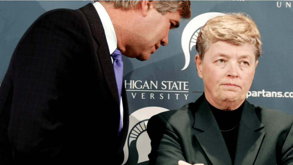 Michigan State University Trustee David L. Porteous, left, speaks with MSU President Lou Anna K. Simon. Simon resigned her position as President Wednesday after Larry Nassar's sentencing.