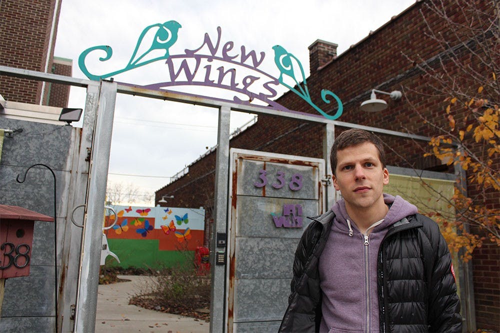 Actor Jesse Eisenberg stands in front of the Middle Way House in Bloomington. Eisenberg has recently worked with a group of IU students to match every dollar raised by the IU student groups for the Middle Way House. 