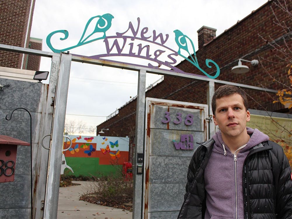 Actor Jesse Eisenberg stands in front of the Middle Way House in Bloomington. Eisenberg has recently worked with a group of IU students to match every dollar raised by the IU student groups for the Middle Way House. 