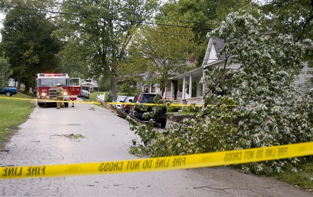 Firefighers block 15th Street near the intersection with Woodburn Avenue after a fallen tree limb brought down several utility lines on Sunday. The remnants of Hurricane Ike pushed north into the midwest over the weekend, bringing high winds and flooding.
