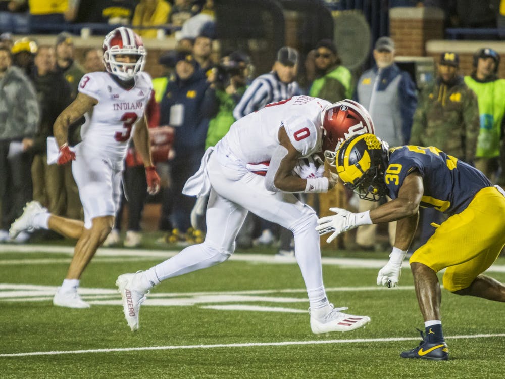 Freshman quarterback Donaven McCulley prepares to be tackled Nov. 6, 2021, at Michigan Stadium. Indiana&#x27;s record is 2-7 after losing to Michigan.