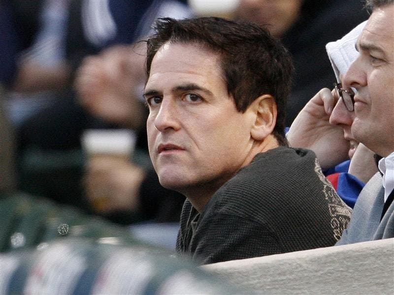 In this April 30, 2008 file photo, Mark Cuban, owner of the Dallas Mavericks NBA basketball team, watches the Chicago Cubs play the Milwaukee Brewers in the first inning of a baseball game in Chicago. Since buying the Dallas Mavericks eight years ago, Mark Cuban has been called a lot of unpleasant things: NBA nuisance, meddling owner, even a bad dancer. Now Cuban is facing the most serious allegation yet - insider trading. 