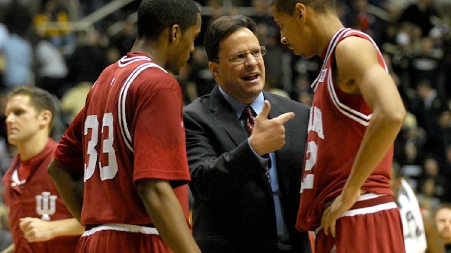 After failing to get a last second shot off before halftime, IU coach Tom Crean discusses the play with Devan Dumes (left) and Verdell Jones (right) before heading into the locker room.
