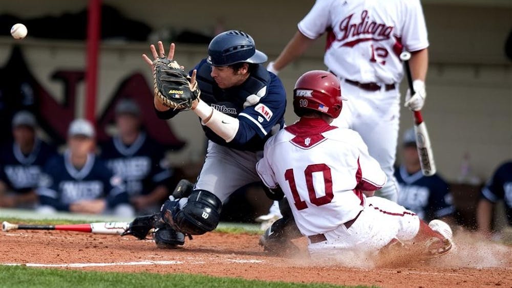 Brian Lambert slides home to score one of his three runs scored during the IU baseball team's home opener against Xavier on Wednesday. The Hoosiers beat the Musketeers 18-7.