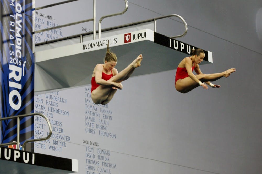 Amy Cozad, left, and Jessica Parratto, right, release out of pike position during the women's synchronized 10-meter preliminaries at the 2016 U.S. Olympic Team Trials in Indianapolis Saturday. 