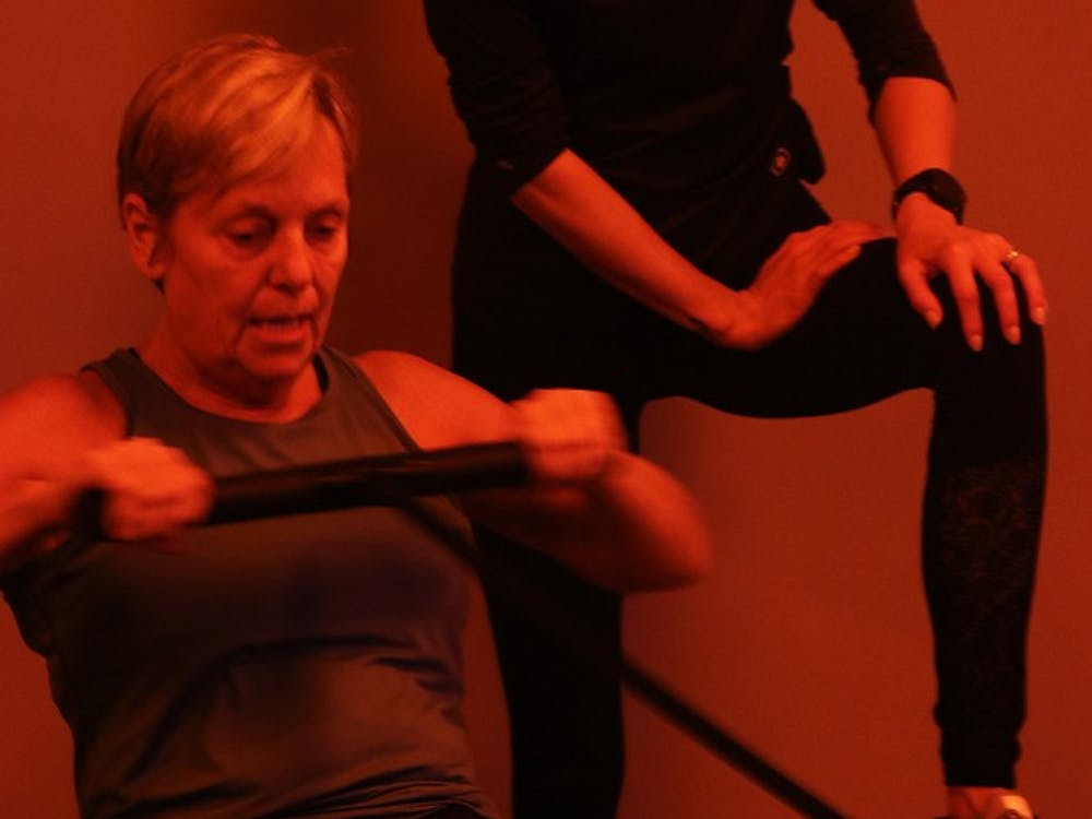 Head Coach Jean Sherfick spends one-on-one time coaching a member through rowing. Sherfick, a former yoga teacher, often reminds her students of their mind-body connection and encourages them to push themselves.
