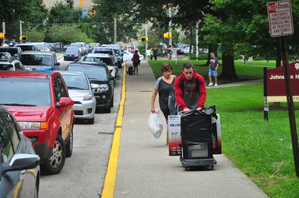 A freshman moves his belongings into his residence hall. Move in day took place on Wednesday and will continue throughout the week.