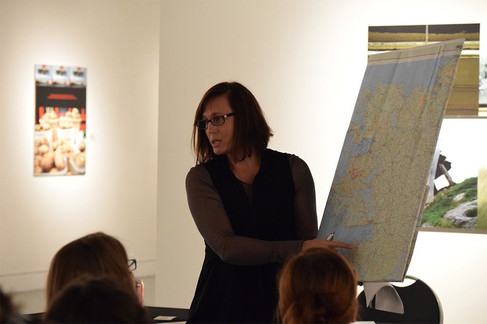 Artist Cynthia O'Dell points to the area of teh Irish countryside she was in while taking a certain set of photographs during a lecture on Friday in Grunwald Gallery. O'Dell has a photographic exhibition titled "Messengers of Yesterday" on display until Nov. 18.