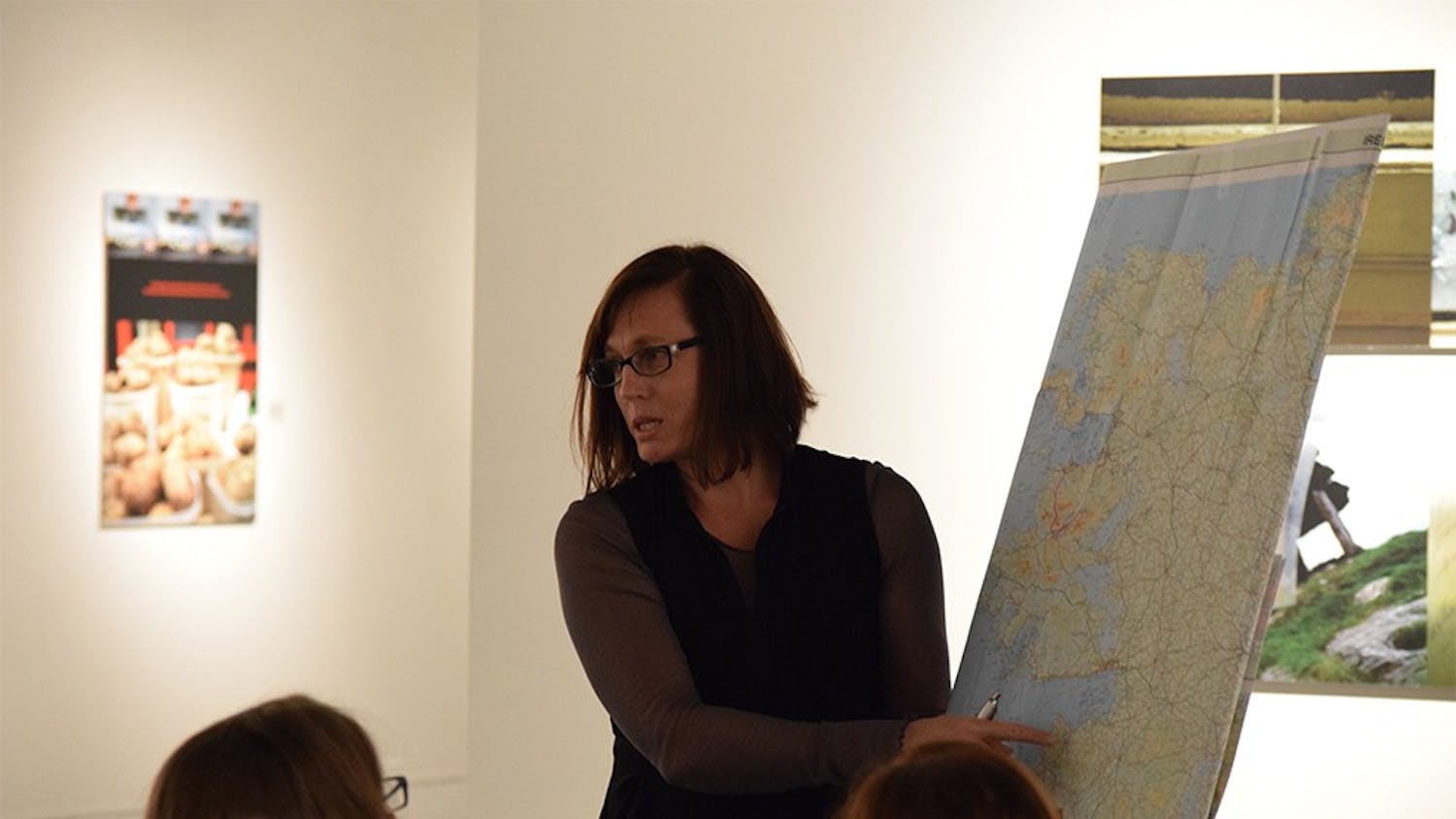 Artist Cynthia O'Dell points to the area of teh Irish countryside she was in while taking a certain set of photographs during a lecture on Friday in Grunwald Gallery. O'Dell has a photographic exhibition titled "Messengers of Yesterday" on display until Nov. 18.