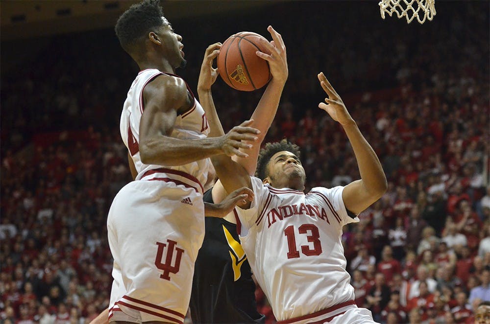 Freshman forward Juwan Morgan and sophomore guard Robert Johnson go up for a rebound against Iowa Thursday at Assembly Hall. The Hoosiers won 85-78.