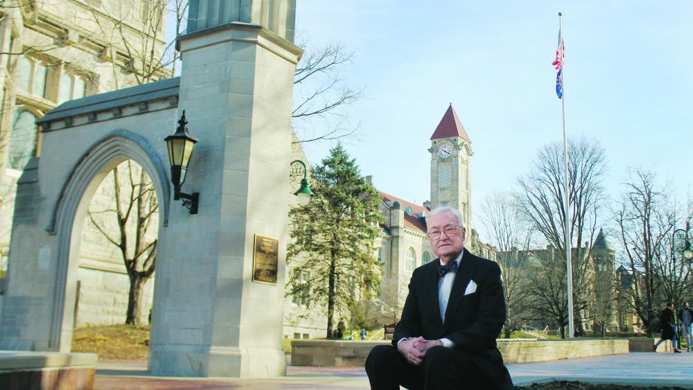 Edson Sample stands in front of the Sample Gates. Sample funded the gates and dedicated them to his parents in June 1987. Before retiring, Sample worked in the Office of Scholarships and Financial Aids at IU for 29 years.