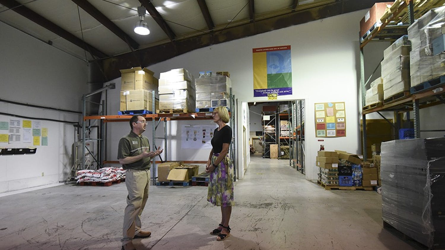 Julio Alonso, executive director of the food bank, gives Suzanne Crouch a tour. The Hoosier Hills Food Bank feeds 26,000 people per year from Bloomington and the surrounding counties. 