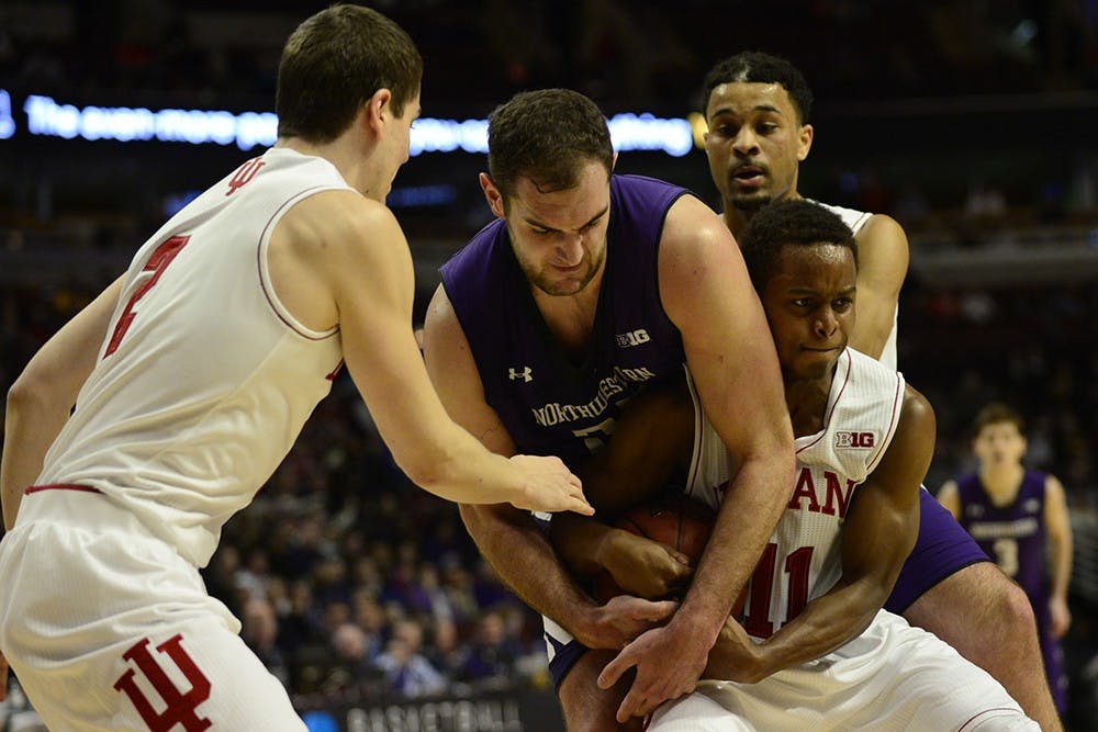 Junior guard Yogi Ferrell fights Northwestern center Alex Olah for the ball during IU's game Thursday at the United Center in Chicago, Ill.
