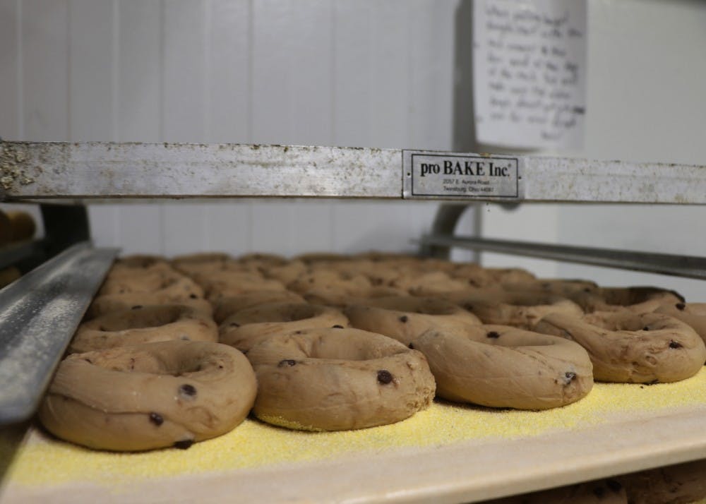Raw cinnamon raisin bagels sit in the cooler waiting to be cooked at night. The bagel dough is made during the day and cooked during the nighttime.
