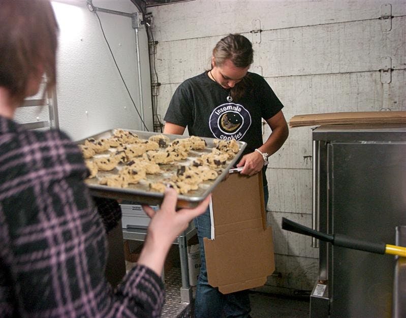 Nacole Costanzo and Rebecca Kish prepare cookies in Insomnia Cookies’ mobile vending truck. Insomnia now operates out of a truck until 2:30 a.m. on weekends to accommodate Bloomington and IU residents on Kirkwood Avenue.