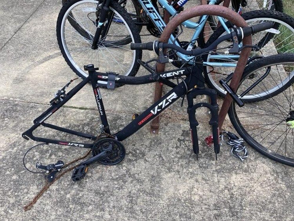 <p>A bike frame with a missing seat and wheels sits outside Read Hall on the IU campus.</p>