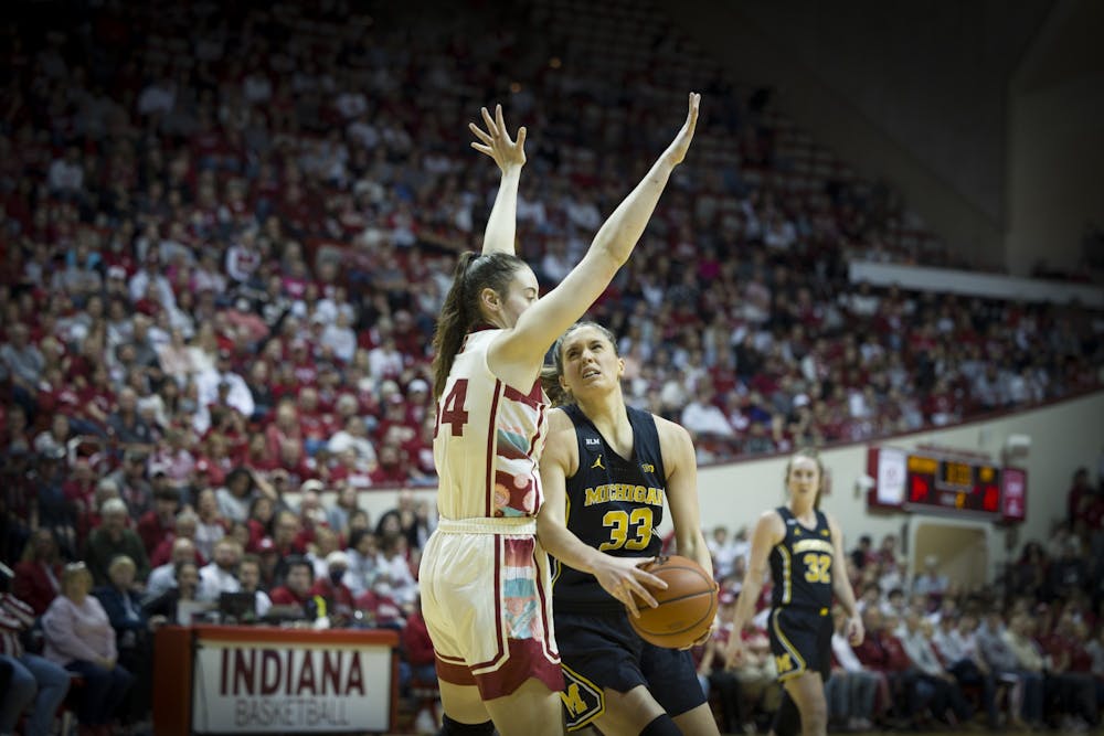 <p>Senior forward Mackenzie Holmes goes for a block against Michigan on Feb. 16, 2023, at Assembly Hall. The Hoosiers beat the Wolverines 68-52.</p>