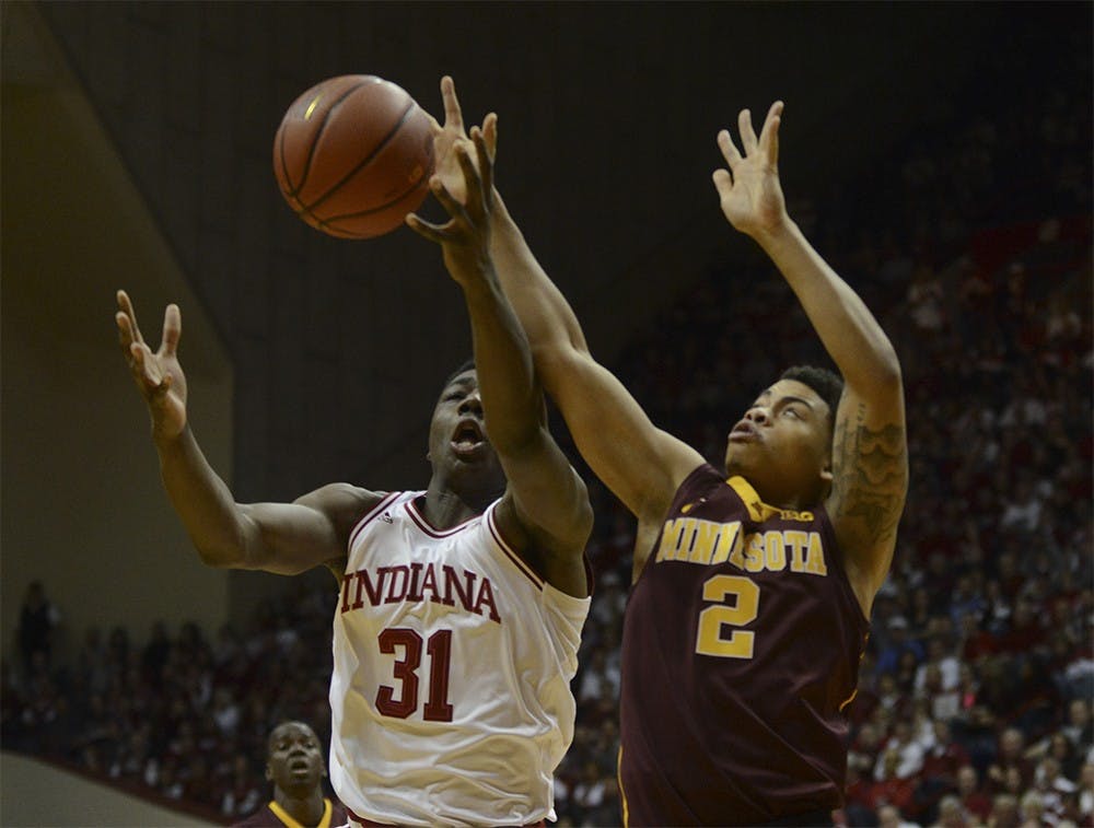 Freshman center Thomas Bryant and Minnesota sophomore guard Nate Mason go after the rebound on Saturday at Assembly Hall. The Hoosiers won 74-48.