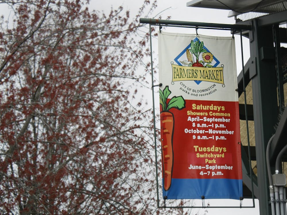 A sign is pictured April 2, 2022, for the Bloomington Community Farmers&#x27; Market. The sign contains dates and times of when the market will be running. 