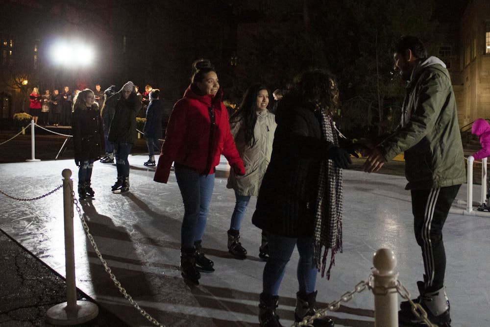 <p>Event attendees skate on an ice rink Dec. 2 in front of the Indiana Memorial Union. The event also included hot chocolate, capella performances and a countdown to light the IMU candle display on the side of the building.</p>
