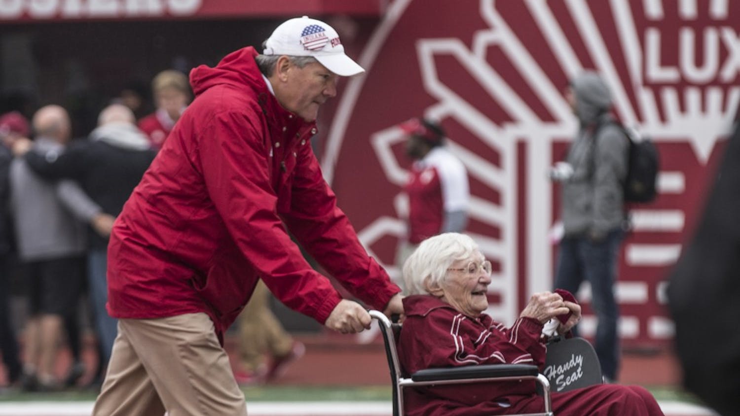 IU Athletics Director Fred Glass wheels the oldest member of 50 Year Varsity Club Donors off the field after an on-field recognition ceremony at the game against Wisconsin on Nov. 4. Glass was appointed athletics director in 2009.