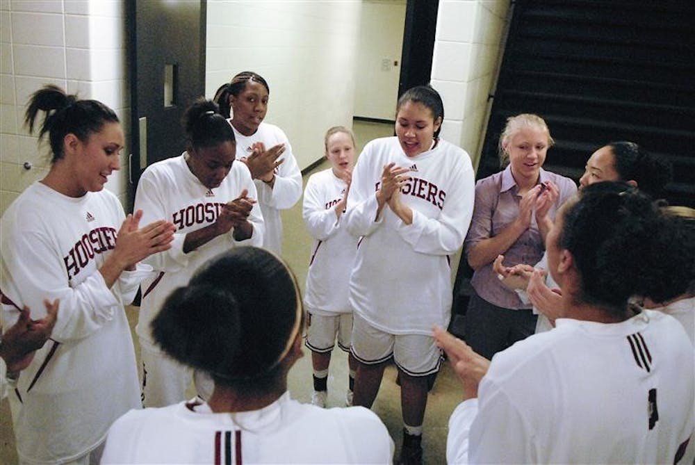 The IU women's basketball team huddle up to sing the IU fight song before taking the court against Wisconsin on Jan. 15 at Assembly Hall.