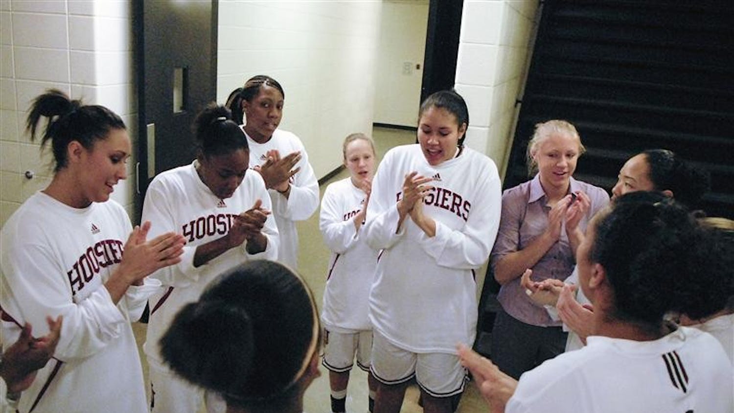 The IU women's basketball team huddle up to sing the IU fight song before taking the court against Wisconsin on Jan. 15 at Assembly Hall.