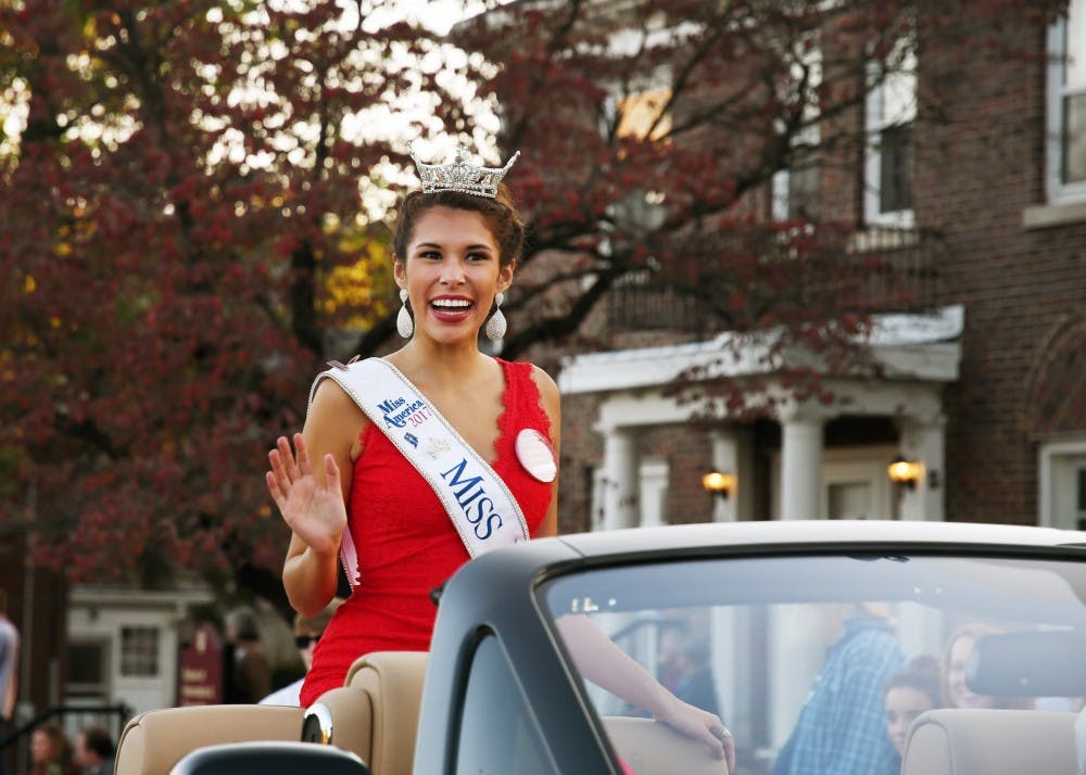 Miss Indiana 2017 Haley Begay waves to the crowd during the homecoming parade Friday evening. The parade started at the IMU and went up Woodlawn Ave.