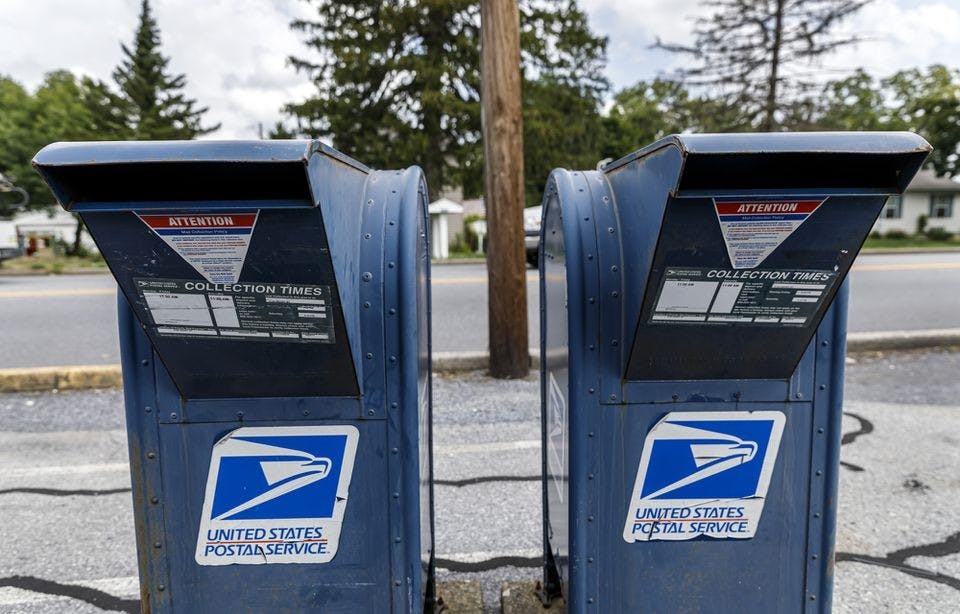 United States Postal Service mail collection boxes sit on a sidewalk in Pennsylvania.