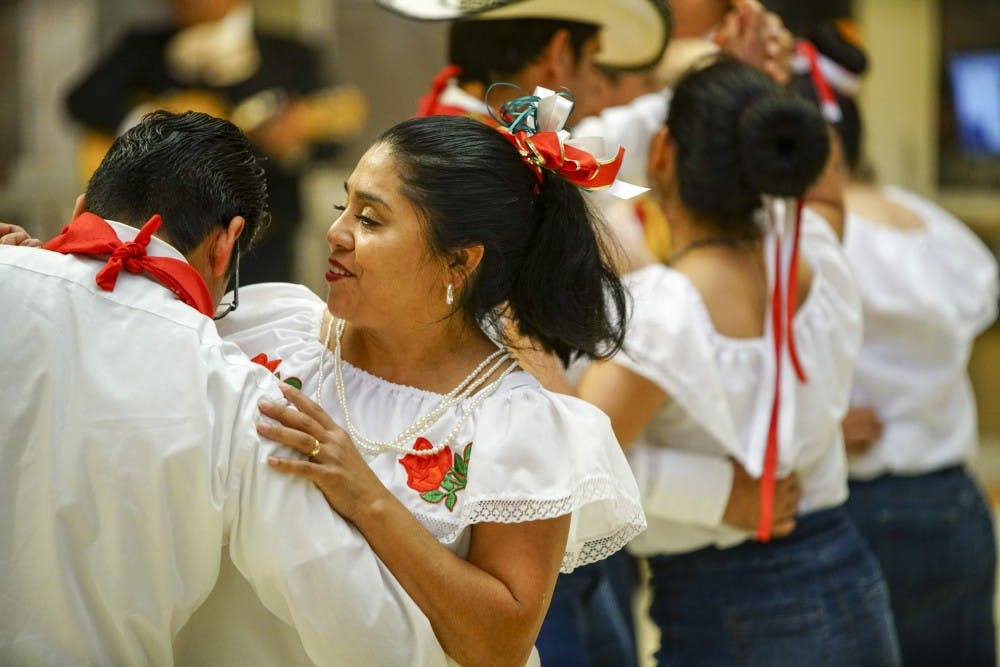 <p>Eduardo Isidro and spouse Leuz Lopez dance with friends to the music of Mariachi Zelaya during the Hispanic Heritage Day Celebration in 2017 in the Monroe County Public Library.</p>