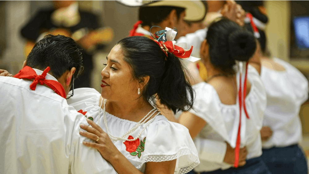 Eduardo Isidro and spouse Leuz Lopez dance with friends to the music of Mariachi Zelaya during the Hispanic Heritage Day Celebration in 2017 in the Monroe County Public Library.