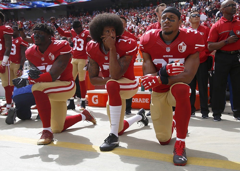 <p>From left, San Francisco 49ers Eli Harold (58), quarterback Colin Kaepernick (7) and Eric Reid (35) kneel during the national anthem before their NFL game against the Dallas Cowboys on Oct. 2, 2016, in Santa Clara, California.</p>