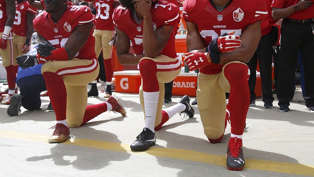 From left, San Francisco 49ers Eli Harold (58), quarterback Colin Kaepernick (7) and Eric Reid (35) kneel during the national anthem before their NFL game against the Dallas Cowboys on Oct. 2, 2016, in Santa Clara, California.